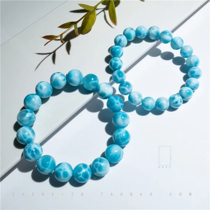 Blue and natural toned bodhi bracelet with a sea-pattern crystal stone centre and pearl accent.
