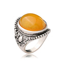 Retro geometric alloy ring in antique silver amber colour on a grey background.