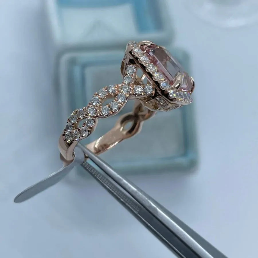Geometric rose gold coloured alloy ring for women and men on a grey background.
