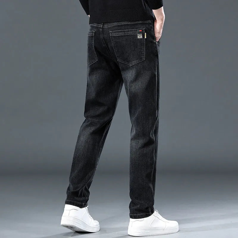 Man wearing blue grey slim straight casual trousers with a loose fit and zip fly for summer street fashion