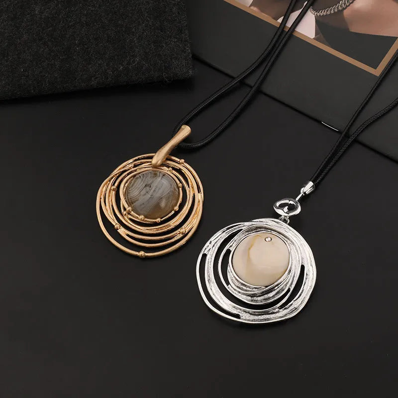 Vintage gold women's necklace with large round plaid pendant on a snake skin chain, shown at adjustable length.
