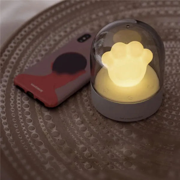 Grey or pink cat paw shaped night light with USB charging port and music box functionality
