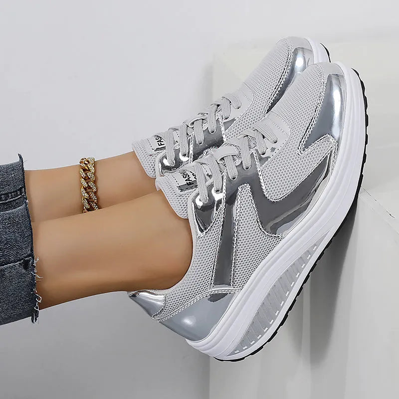 Women's gold patent leather mesh sports shoes with cross straps and platform sole.