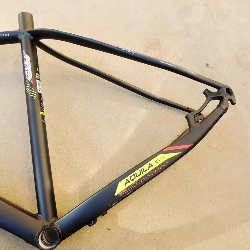 Black green aluminium 29-inch mountain bike frame showing disc brake mount and inner cable ports.