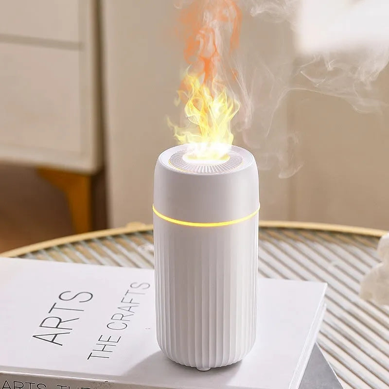Car aroma diffuser with simulated flame effect showing black unit with mist output