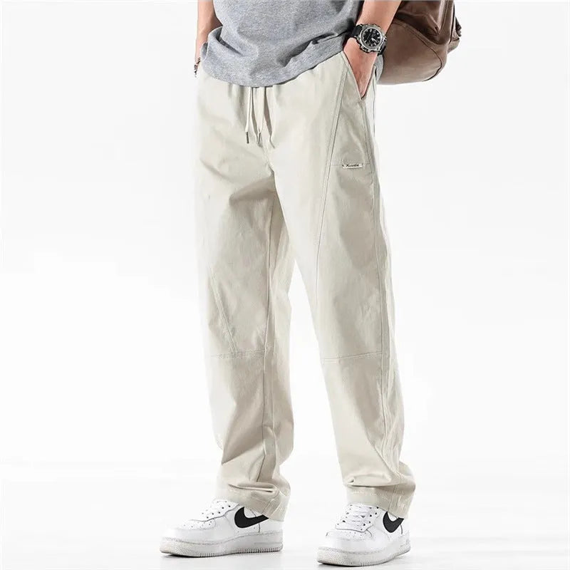 Women's milky white cotton wide-leg trousers with an elasticated waistband on a hanger.
