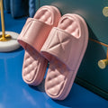 A pair of soft EVA bathroom slippers with a thick, textured non-slip sole in a choice of colours.