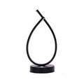 Black water drop shaped USB desk lamp with touch control on a wooden table