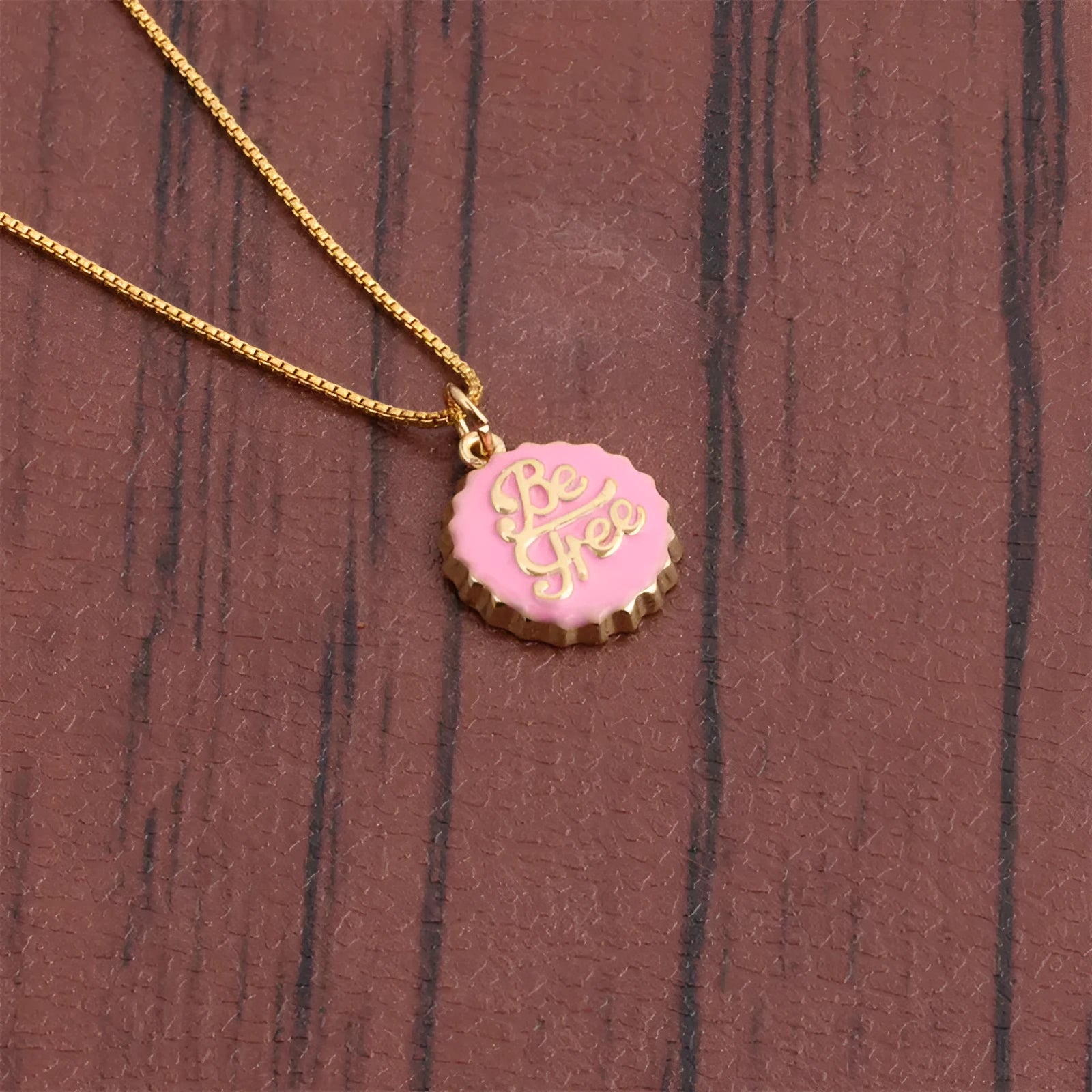 Gold-plated copper Be Free bottle cap pendant necklace on a 40cm box chain.