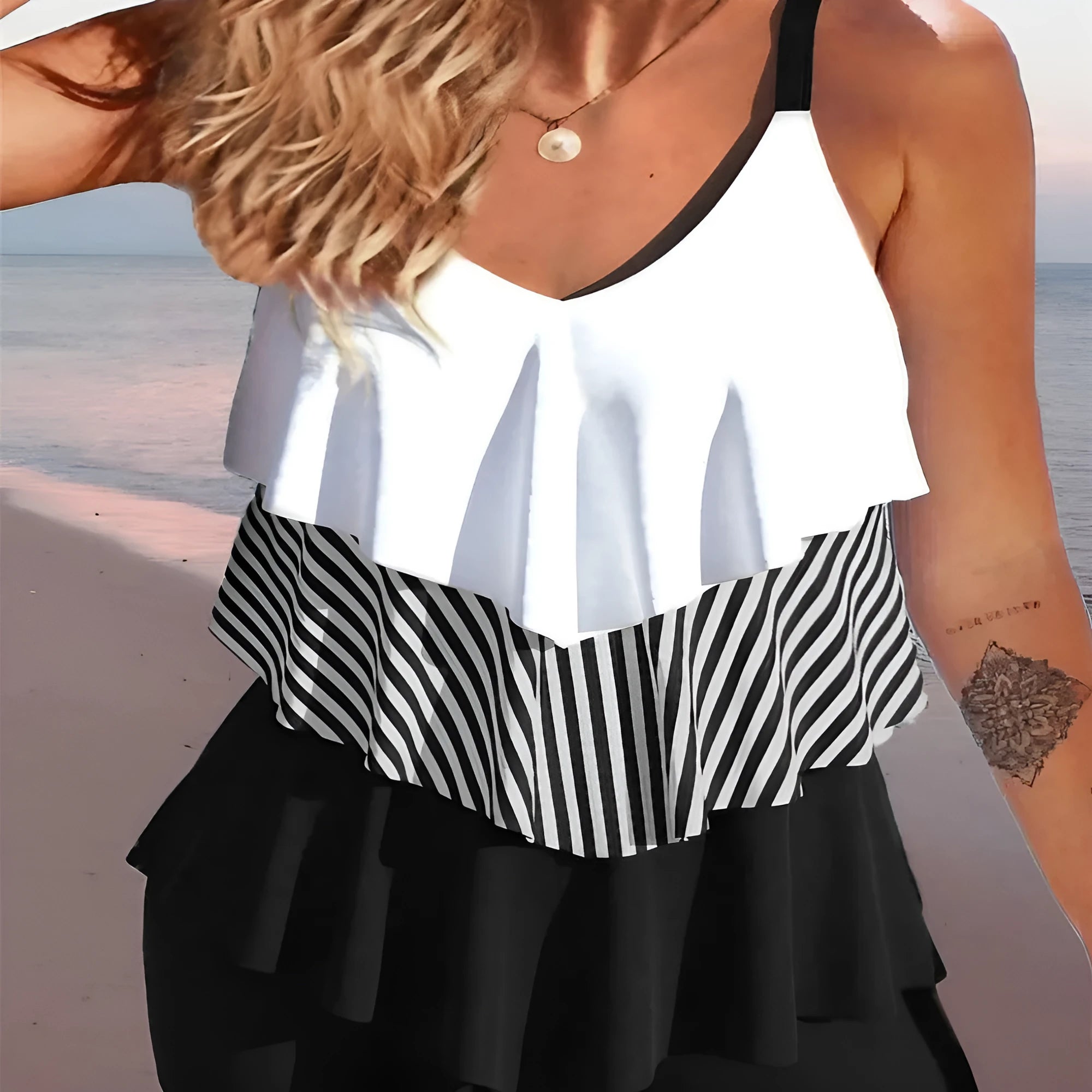 Women's sleeveless backless bikini with ruffles and spaghetti straps, shown in a floral print.