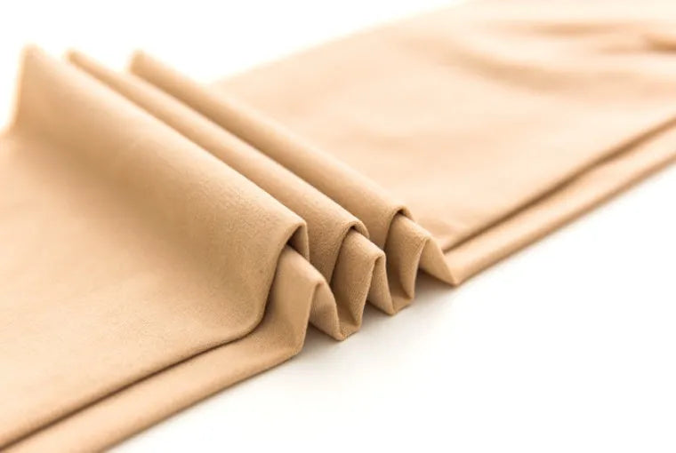 Beige and black stovepipe shaping socks for hip and abdomen support in polyester fibre material.