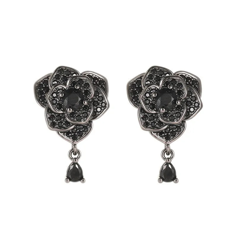 A pair of black rose zircon floral stud earrings with an 18K gold electroplated finish on copper.