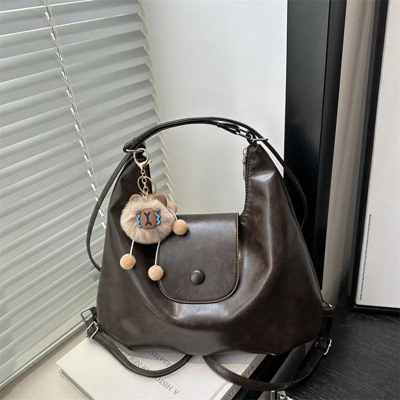 Leather women's shoulder bag in brown colour with single strap and structured horizontal design