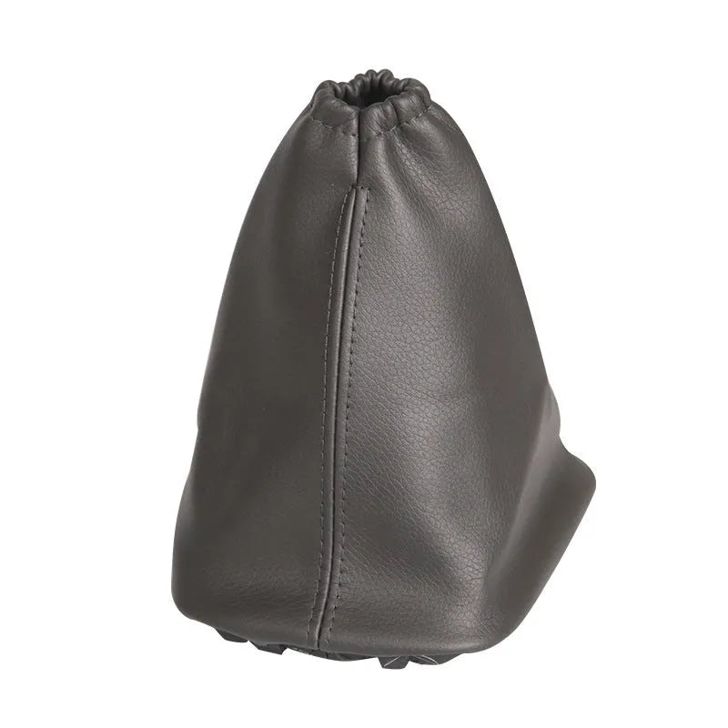 Black leather dust cover for Toyota Corolla gear shift lever, shown beside vehicle interior