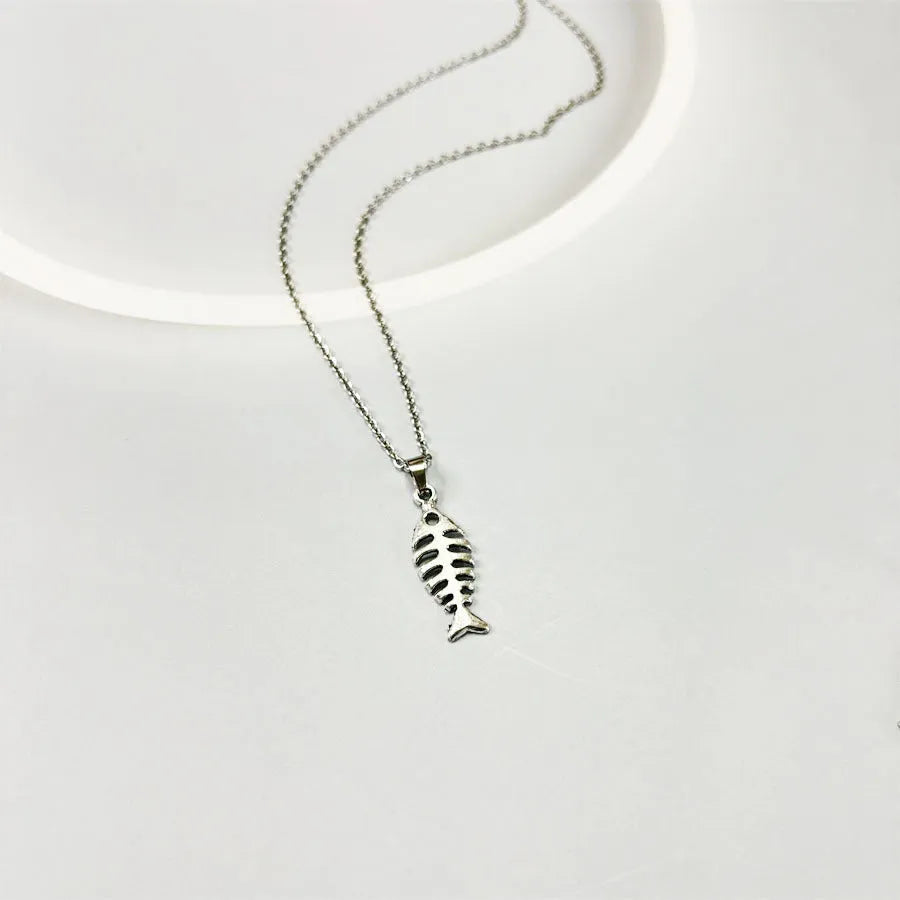 Fishbone pendant earrings and matching necklace set with adjustable chain on grey background