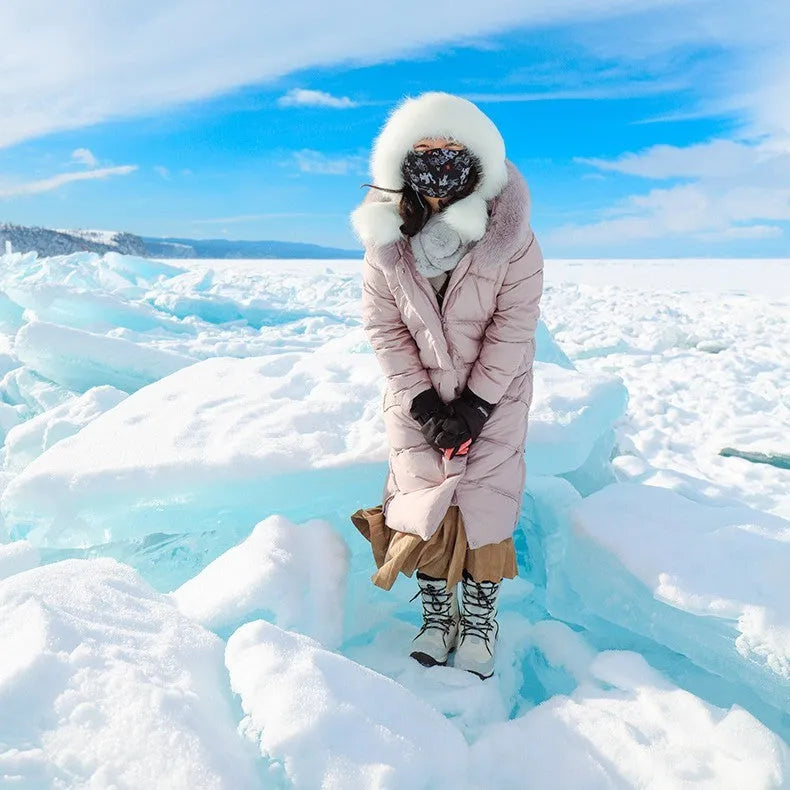 Black women's mid-calf leather snow boots with a round toe and thick rubber sole on a white background.