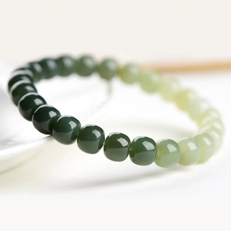 Natural Hetian jade bracelet with water gradient colour on a wrist.