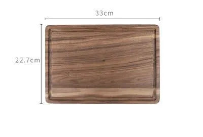 Solid black walnut wood cutting board with juice groove and side handle, shown in round and rectangular sizes.