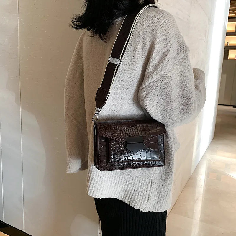 Vintage style crossbody bag in PU material showing 20cm width with four colour options