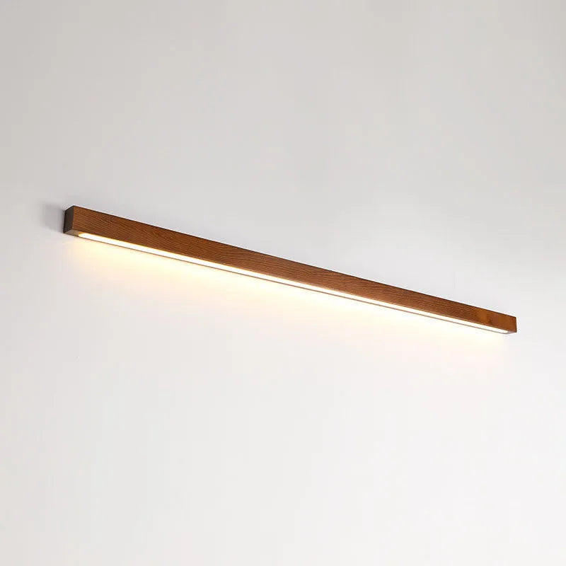 Walnut colour wooden log design LED strip wall lamp in three lengths on a modern wall.