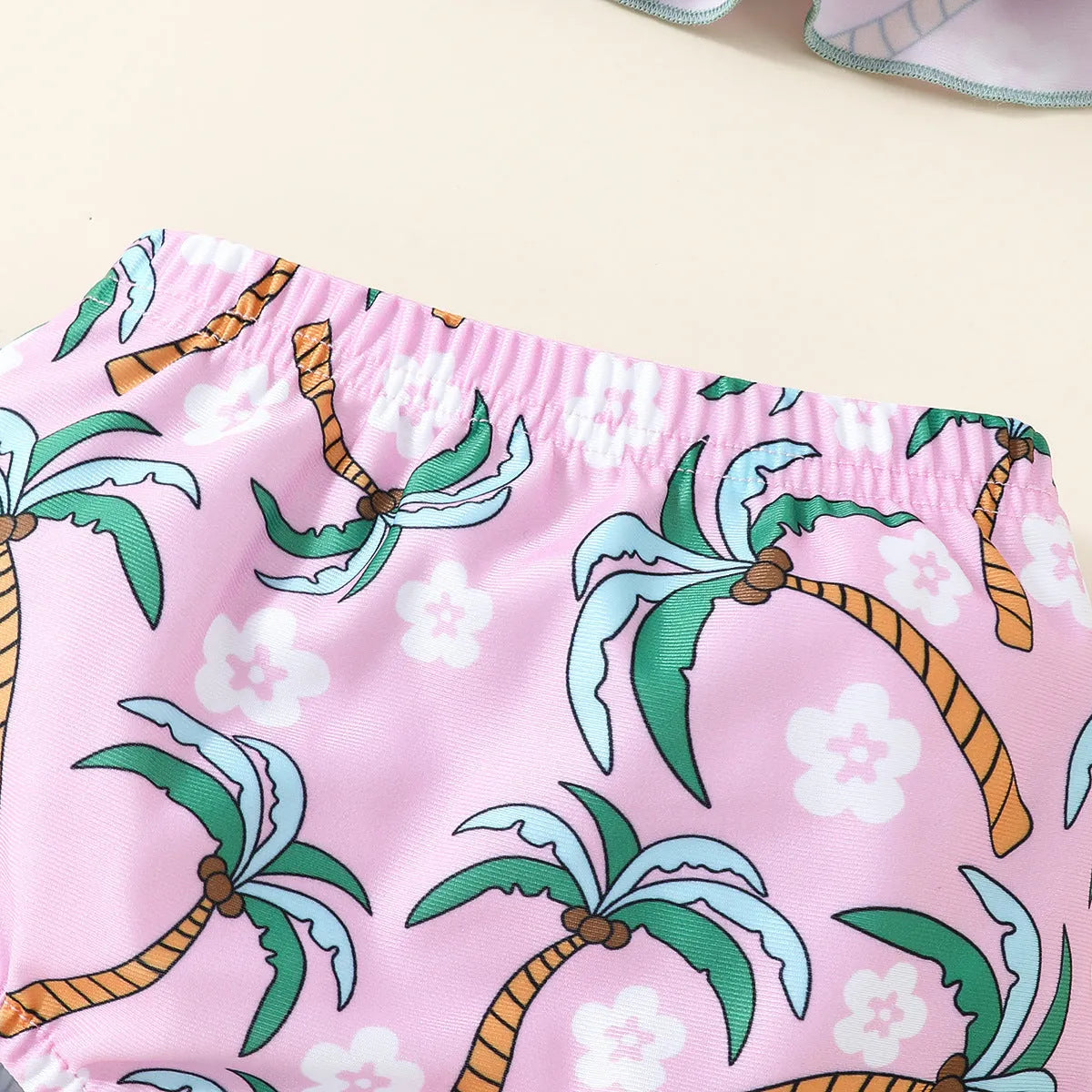 White toddler boy two-piece swimsuit set with shirt and beach shorts on a hanger
