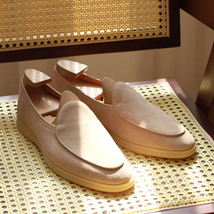 Men's black genuine leather handmade loafers with a flat sole and low-cut ankle design.