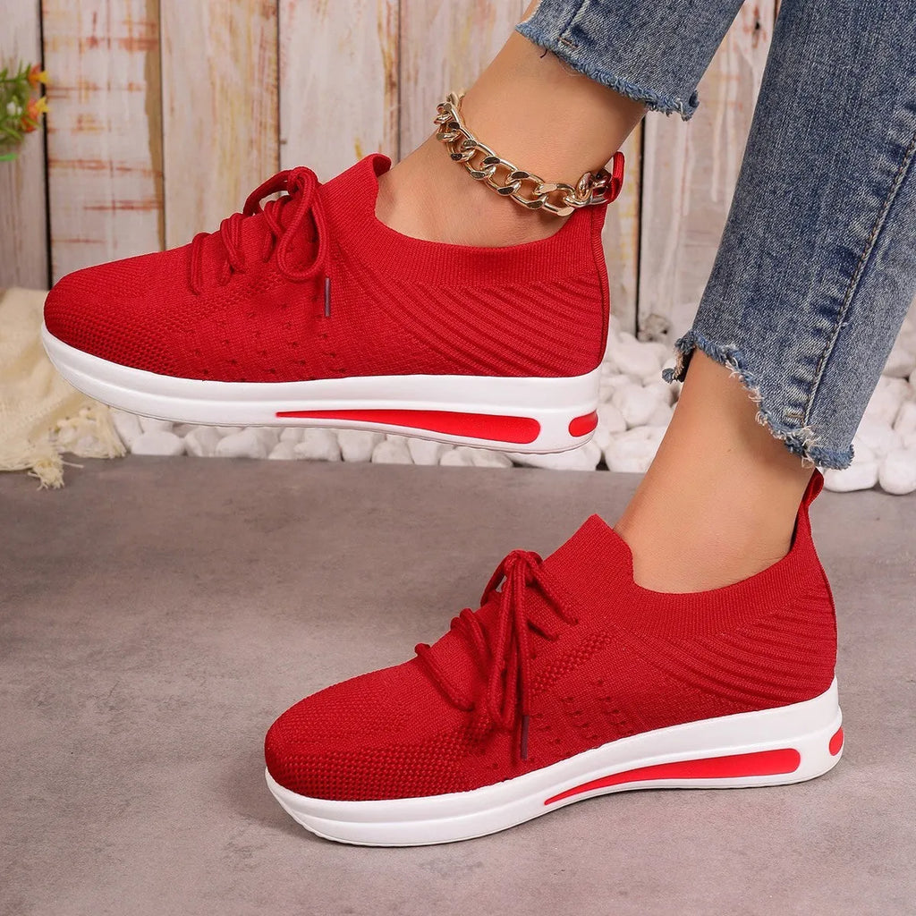Women's red, black, and blue low-top casual sneakers with a round toe and lace-up front.