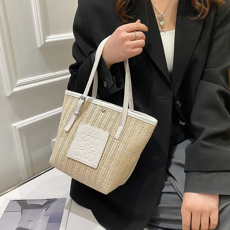 Straw woven women's shoulder bag in black with three-dimensional pockets and 27cm width