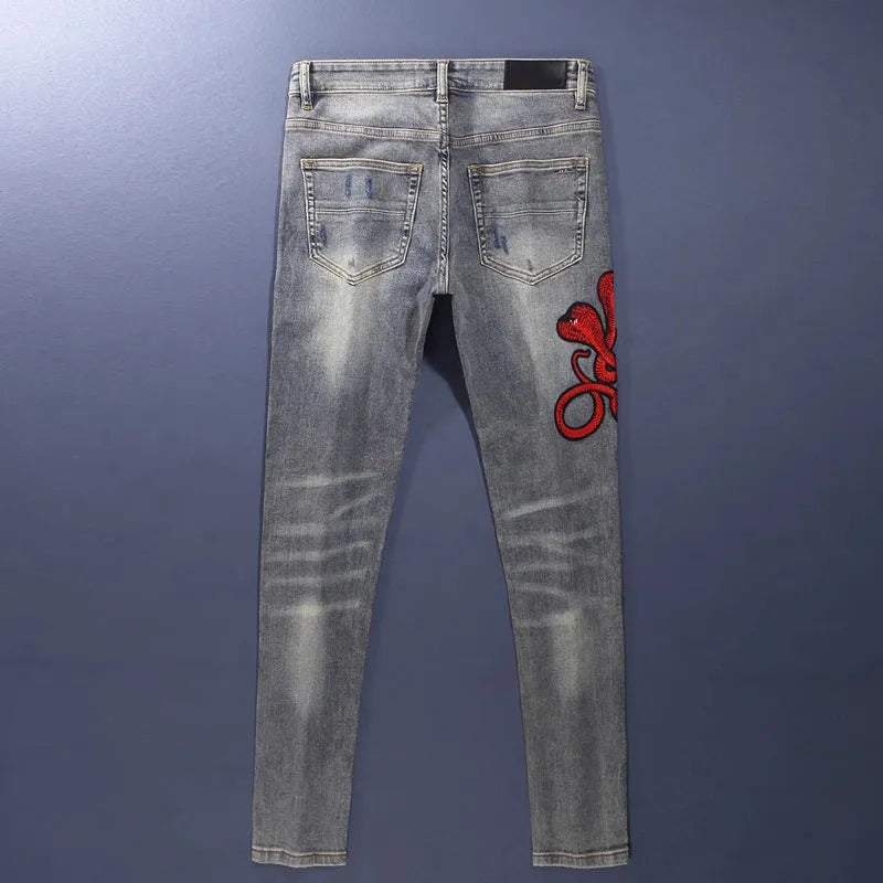 Slim fit jeans in washed-out old colour with patch embroidery detail on the leg.