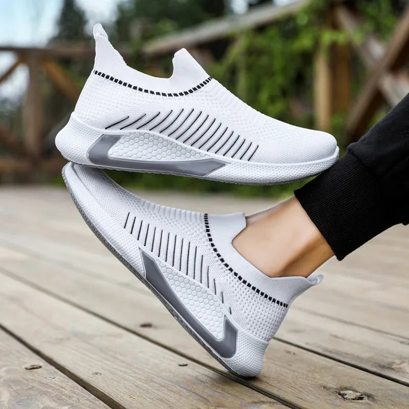 Men's black and white striped mesh sock shoes with Flyknit upper and lace-up front.