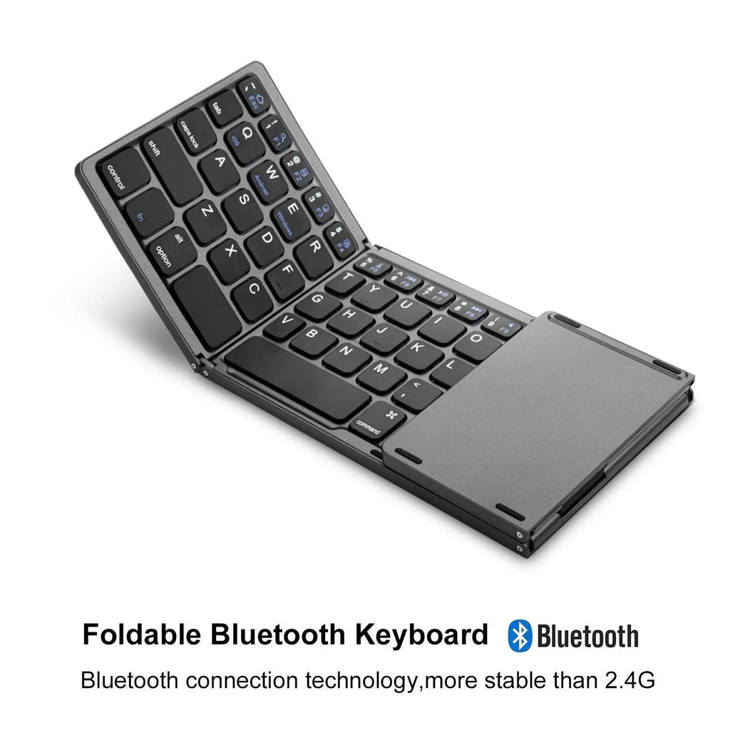 Black tri-fold portable Bluetooth keyboard shown open next to a smartphone, demonstrating its compact size.