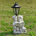 Hexagonal solar garden lamp with decorative resin animal design in outdoor setting