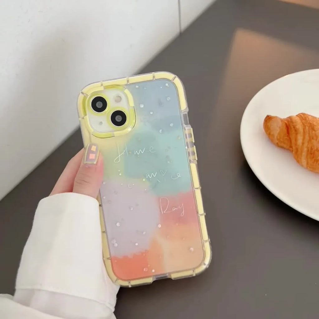 Minimalist yellow edge silicone phone case for iPhone 14 on a table.