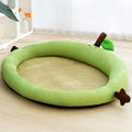 Green fruit-shaped pet nest with a raised backrest edge for dogs and cats on a wooden floor.