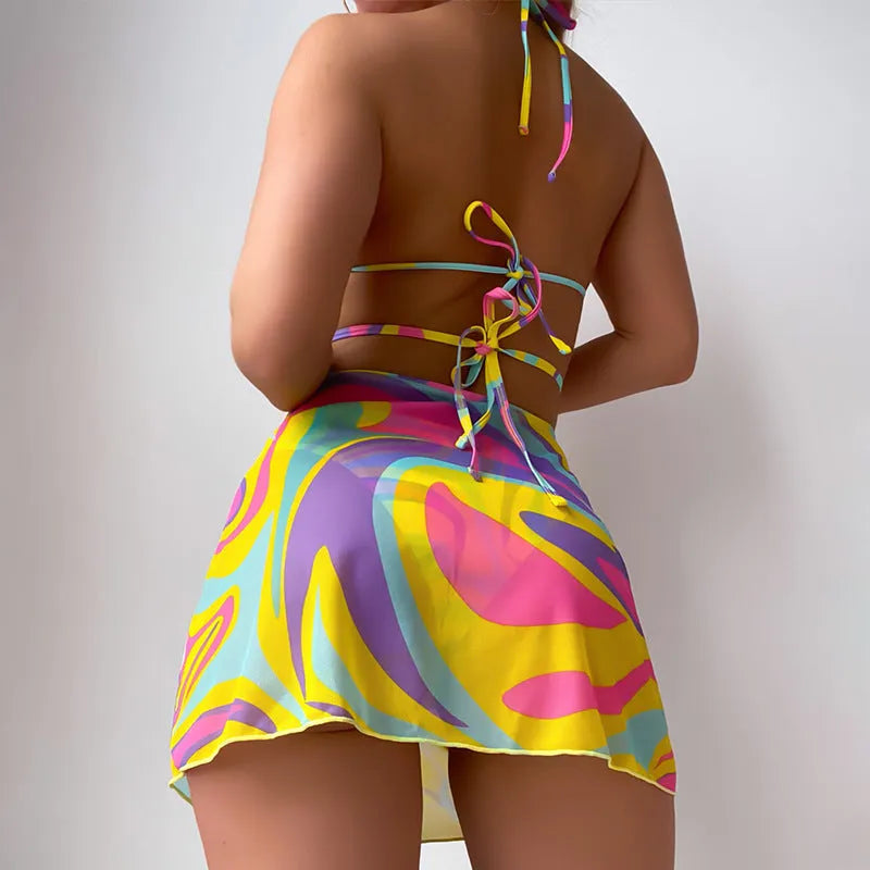 Yellow striped halter swimsuit for women with lace-up front, matching skirt, and shorts.