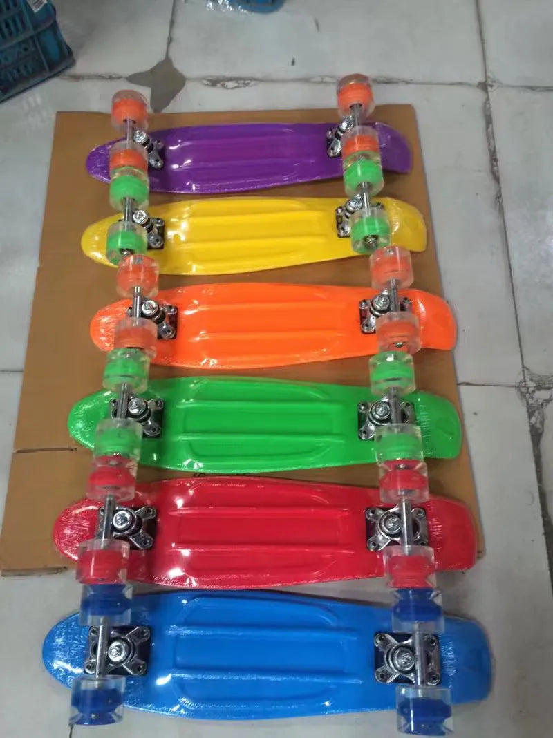 Four-wheel skateboard with blue PP deck, magnesium aluminium trucks, and flashing PU wheels on white background