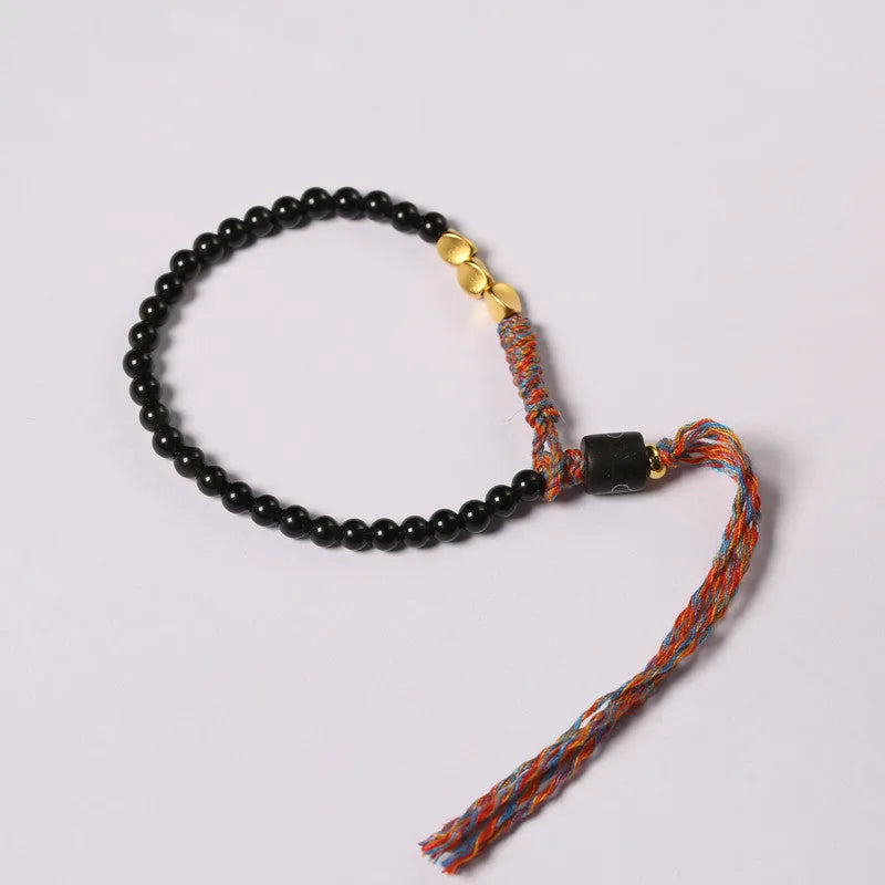 Hand-woven obsidian carrying strap bracelet showing textured detail and adjustable 15.5-16cm length
