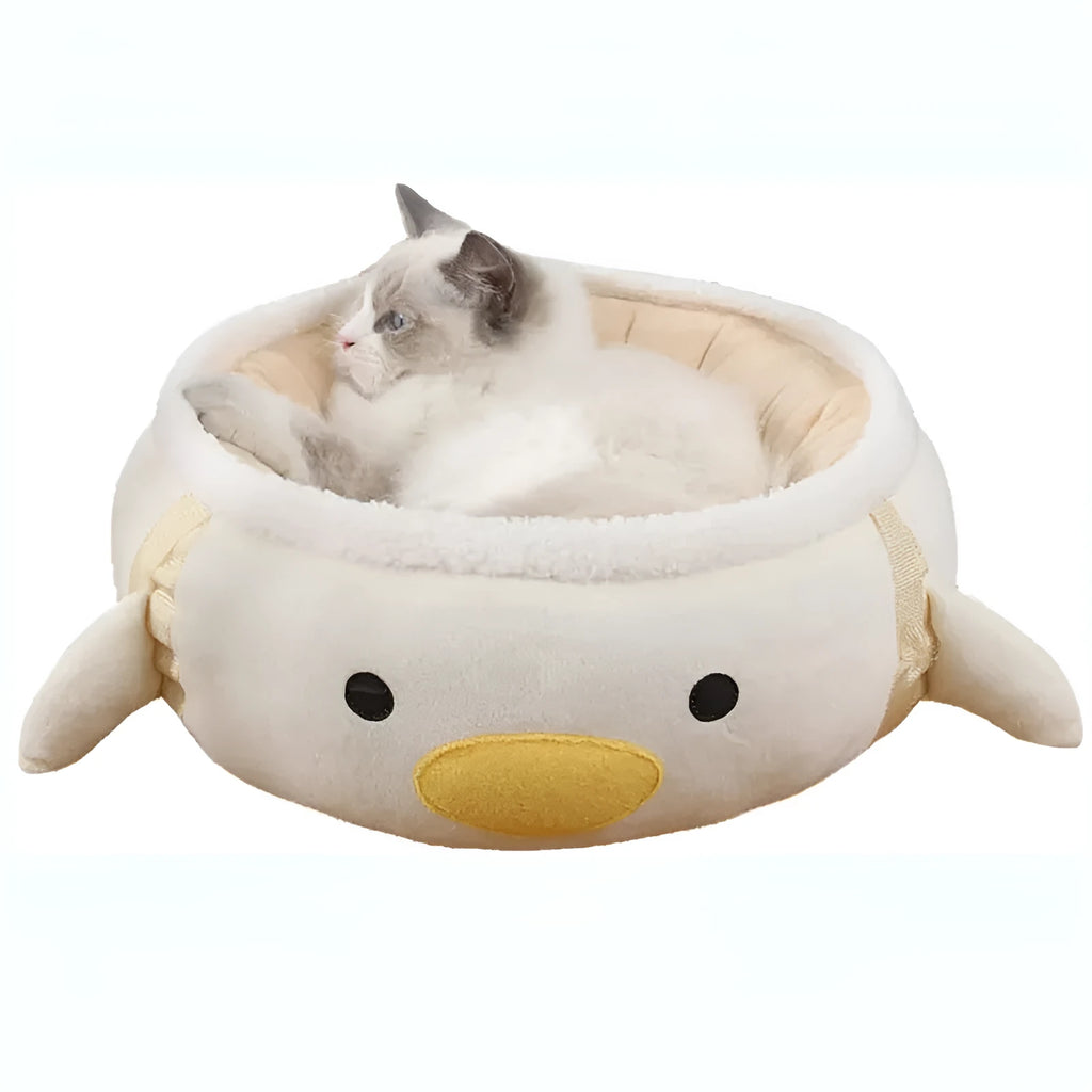 Green dinosaur-shaped cat bed shown both flat and hanging as a hammock for small cats.