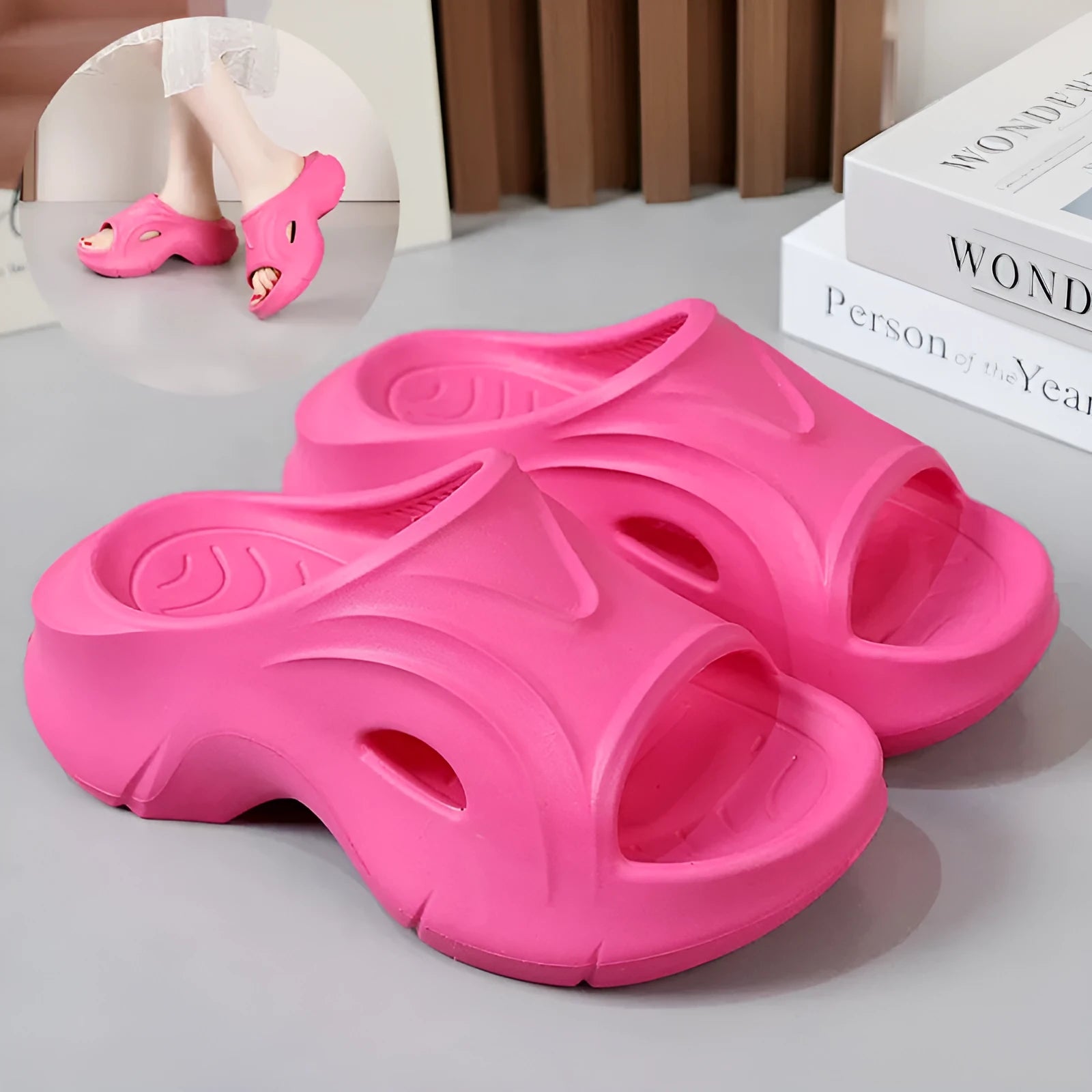 White women's EVA slippers with thick sole and round toe on a beach background.