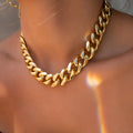 Women's gold thick chain necklace showing 32cm length with 6cm pendant detail