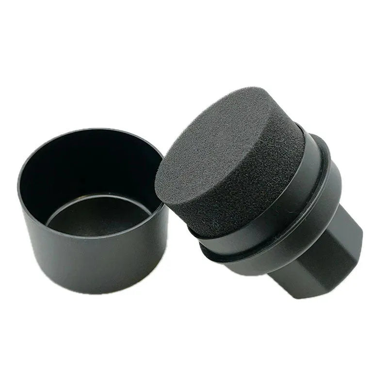 Black and red tyre polishing sponge brushes with protective lids on a white background