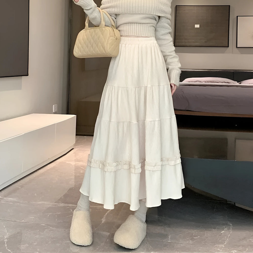 Korean style corduroy A-line midi skirt with elastic waistband in solid colour on hanger.