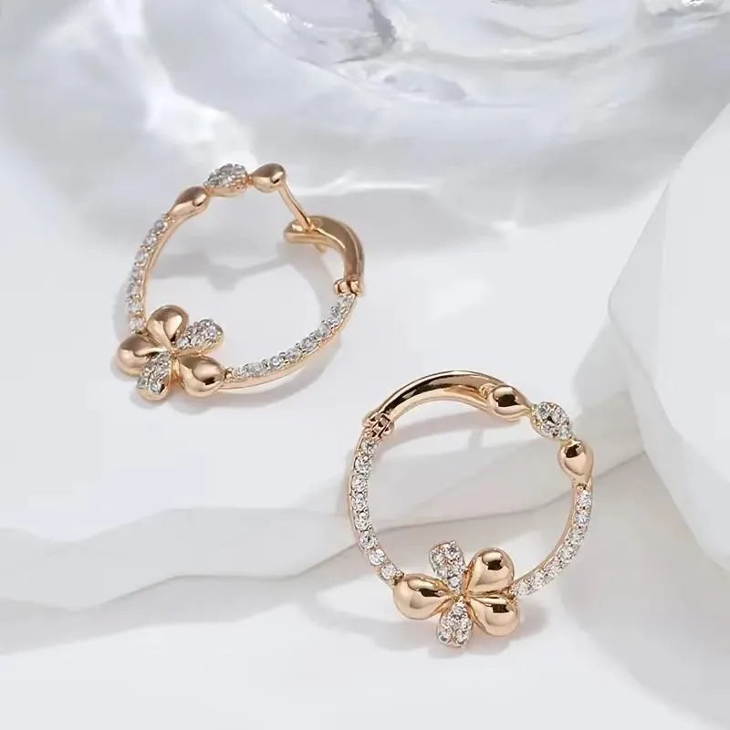 A pair of geometric round ring earrings for women in an electroplated copper finish.