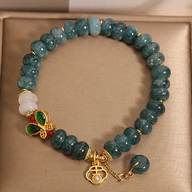 Blue water jade bracelet with white agate abacus beads and butterfly charm