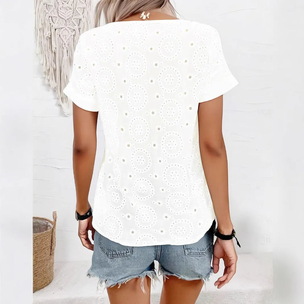 White women's V-neck t-shirt with hollow out detail and loose fit short sleeves.