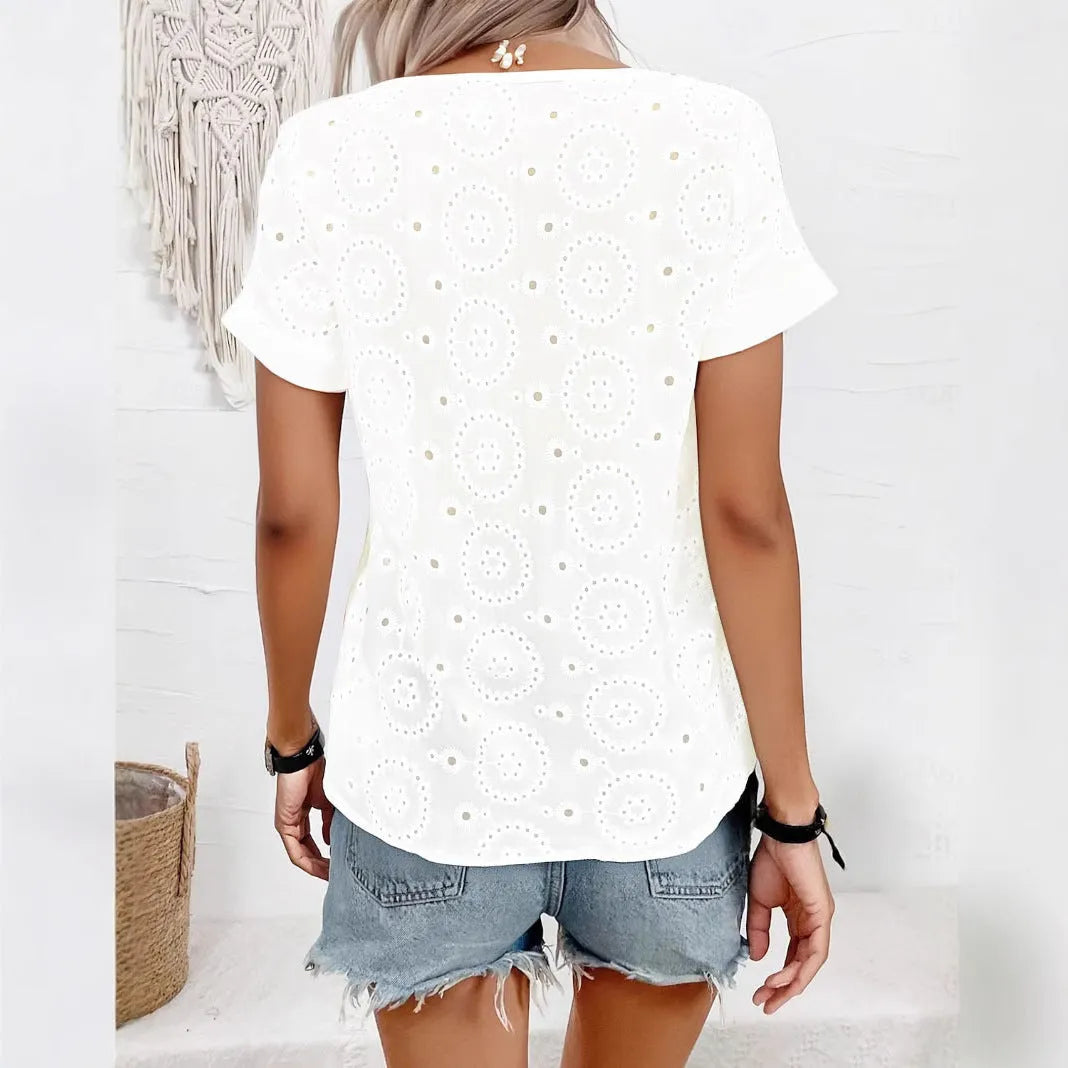 White women's V-neck t-shirt with hollow out detail and loose fit short sleeves.
