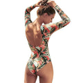 Women's leaf print floral backless one-piece swimsuit on a mannequin.