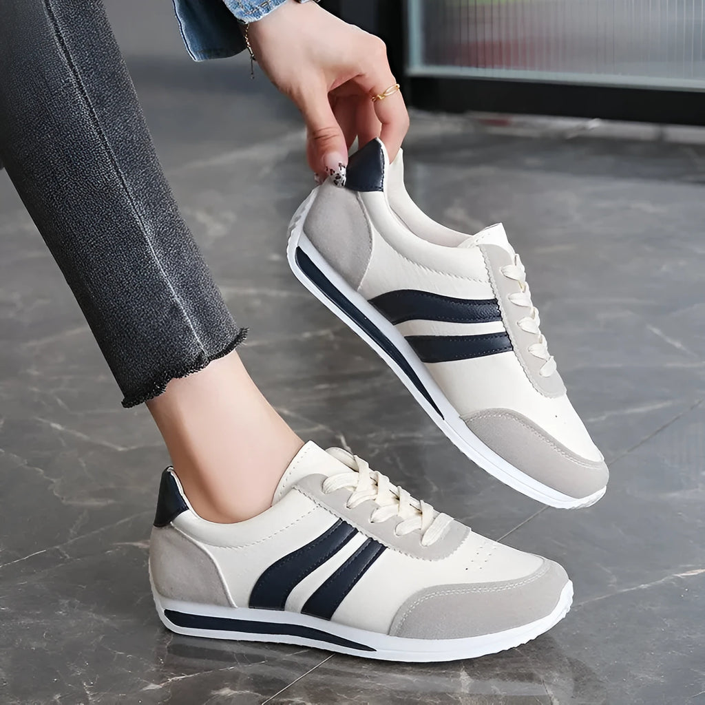 Red and blue lace-up running sneakers with mesh upper and flat rubber soles