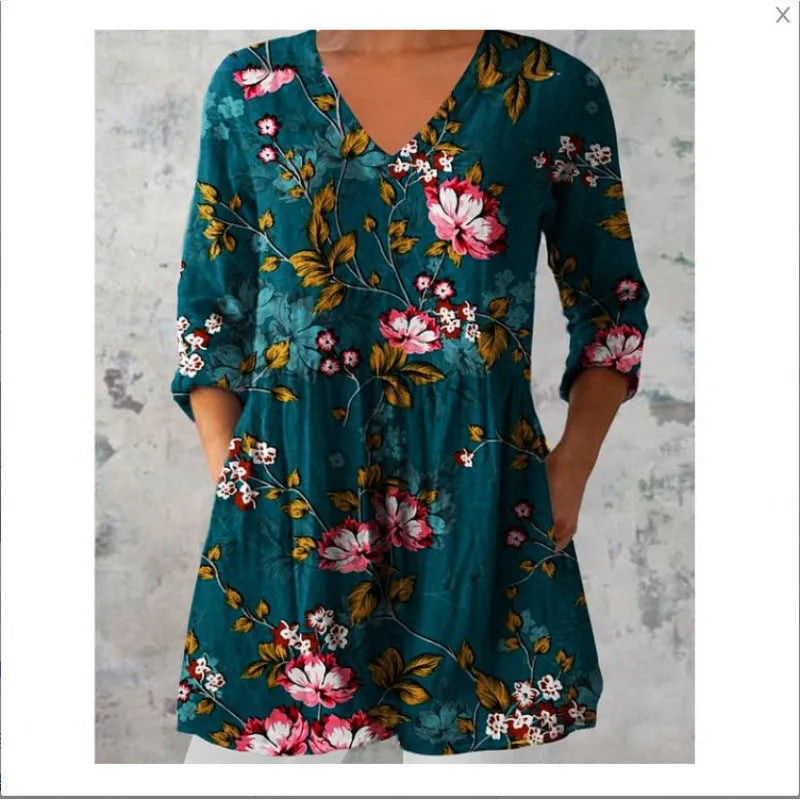 Printed women's loose dress with wide waist and three-quarter length sleeves on a hanger.