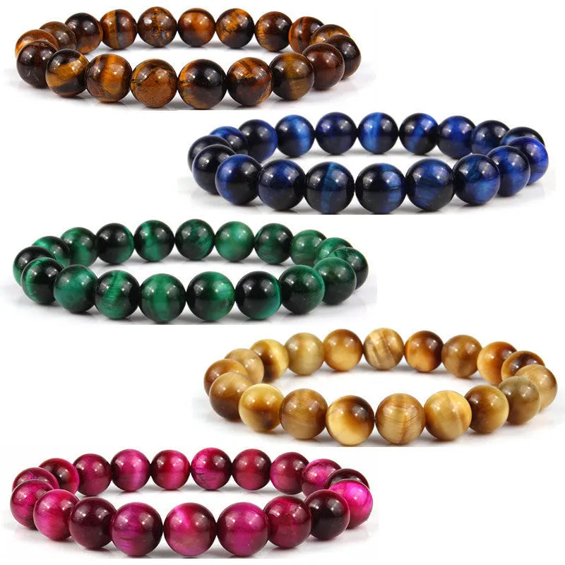 Natural tiger's eye crystal bead bracelet with round beads on a wrist, showing colour variations.